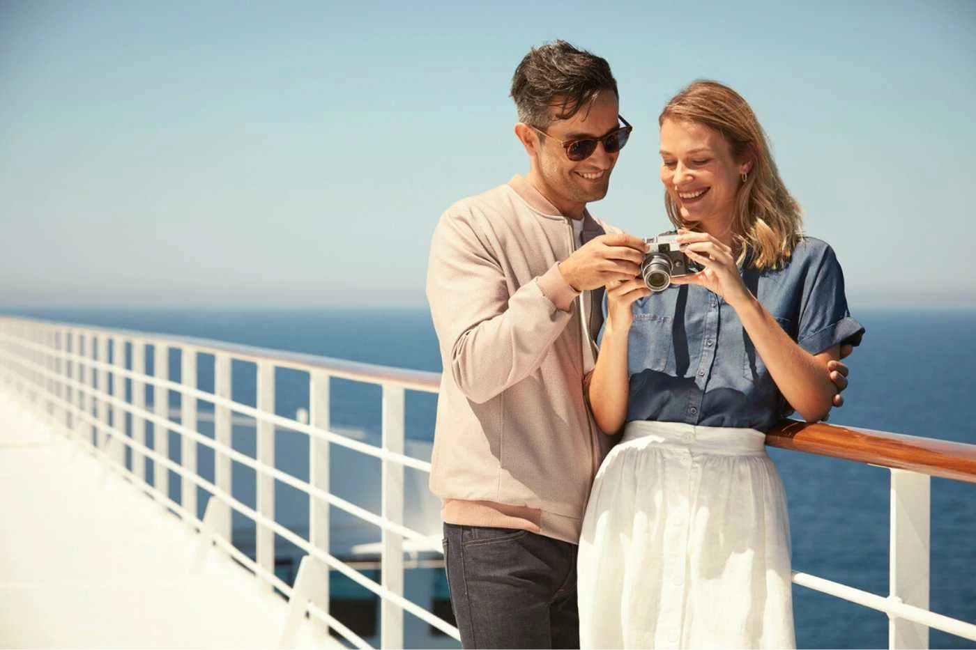 Cruise guests relaxing on a premium deck with sea views
