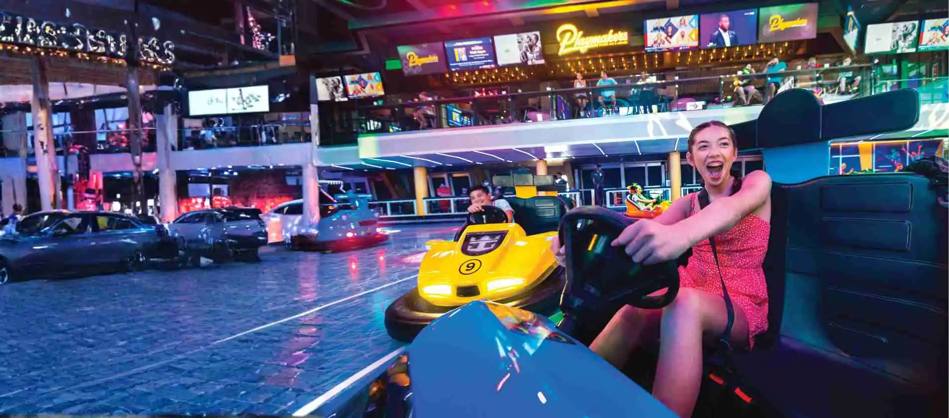 Guest enjoying the go-kart speedway at a cruise ship entertainment venue